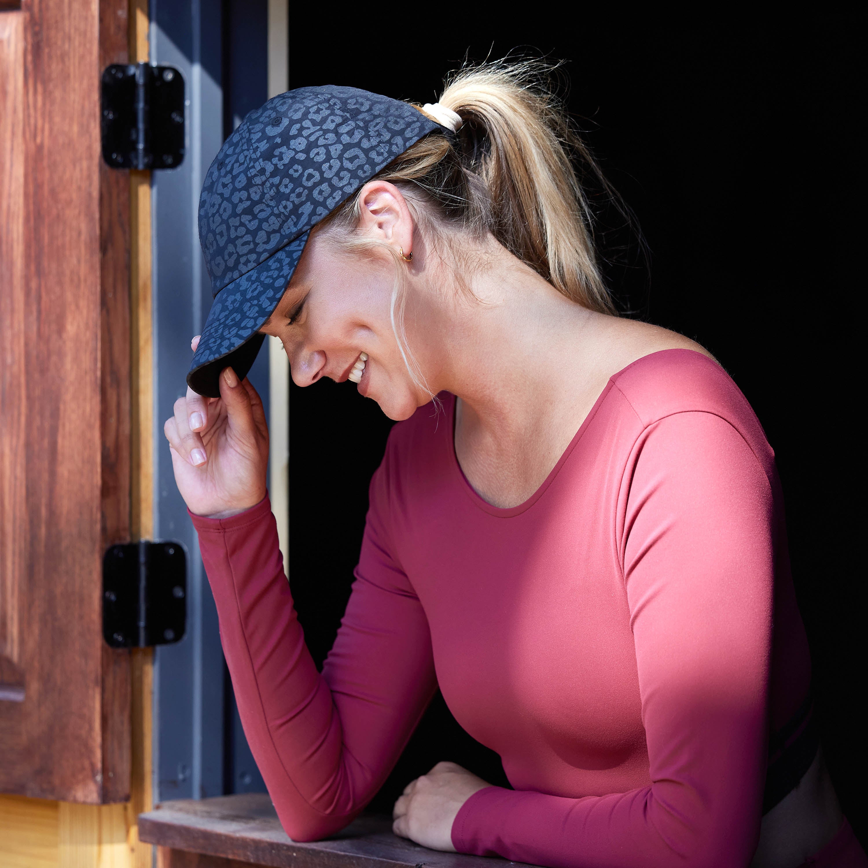 Side view of person wearing the Gaiam  Classic Leopard Print Hat black