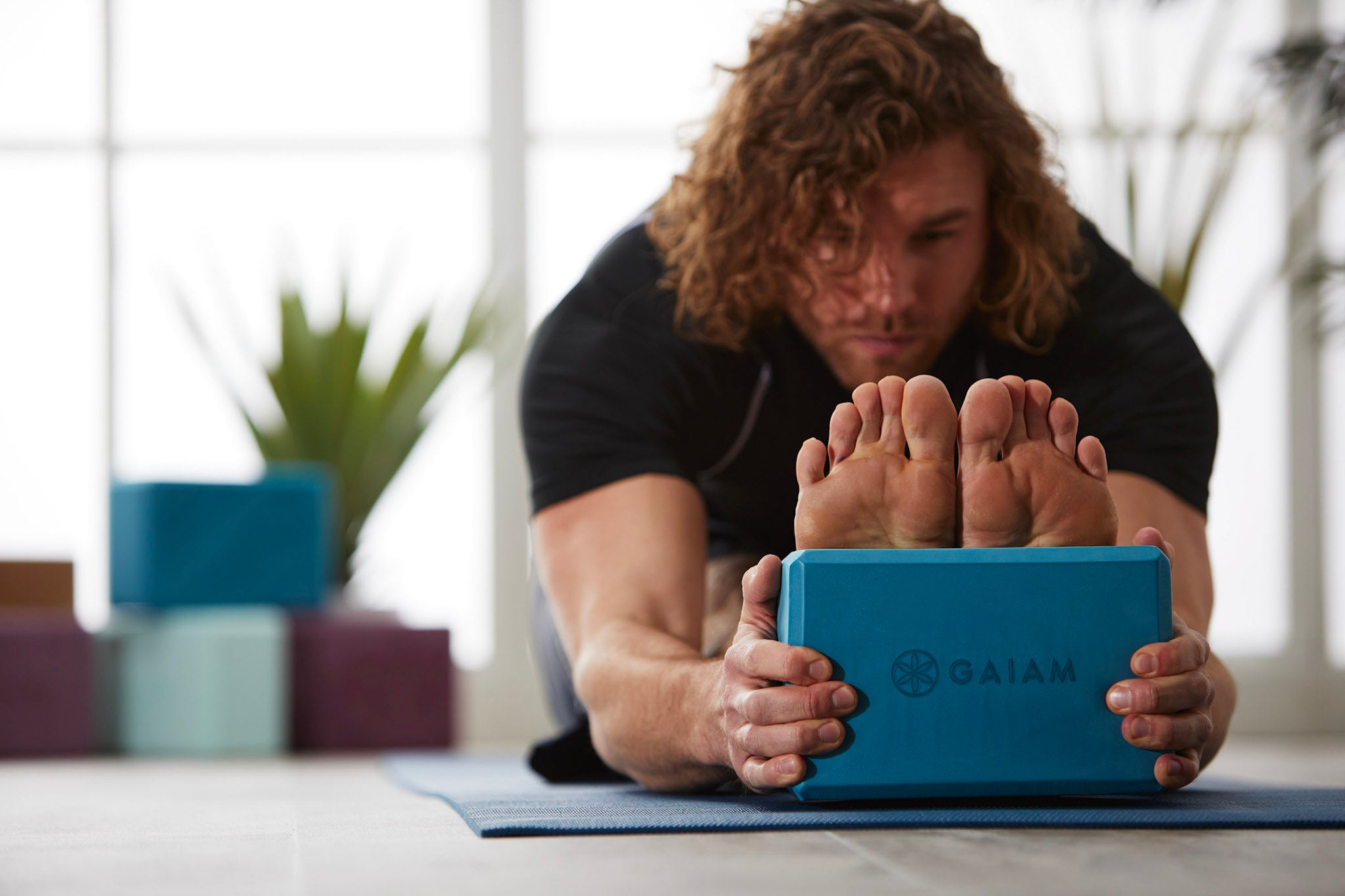 Person in forward fold with yoga block